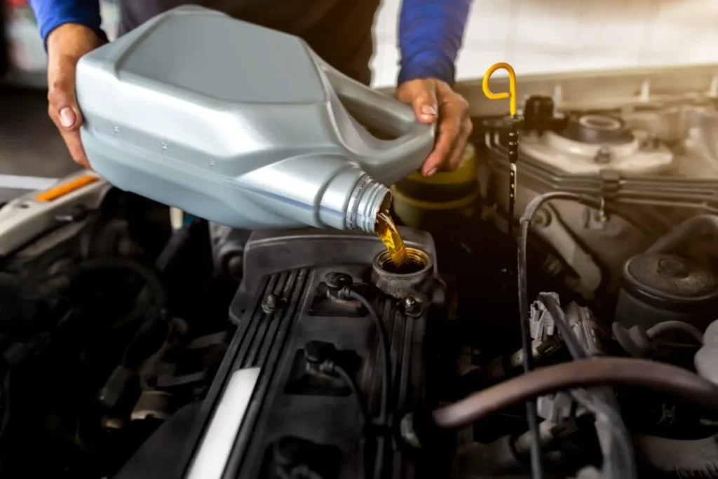 Pouring oil into engine